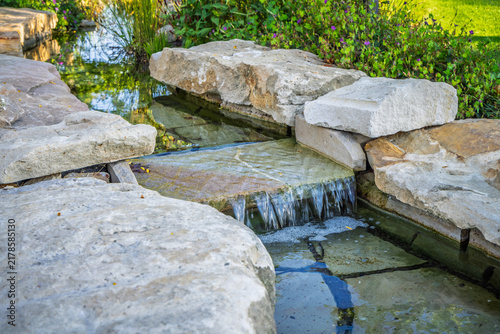 Sticker Modern garden water feature with cascading waterfall and stone pond