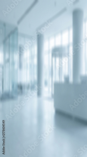 A bright and airy blurred modern office lobby interior featuring clean architectural lines and soft natural daylight for professional corporate business background design projects