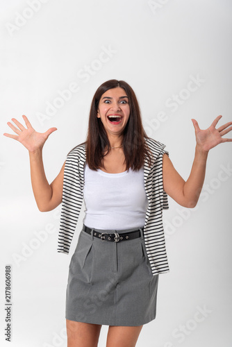 Cuadro en lienzo Young woman with long hair, wide eyes and open mouth expressing excited surprise