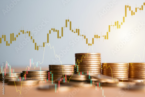 Golden Coin Stacks with Stock Market Candlestick Chart Overlay Representing Financial Growth and Trading