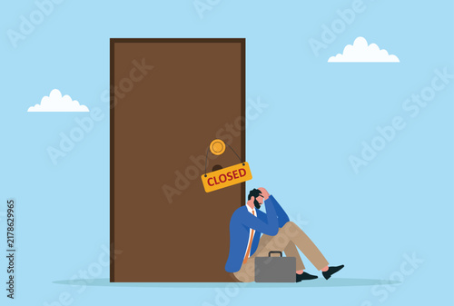 Businessman sitting outside closed office door, unemployment and business failure concept