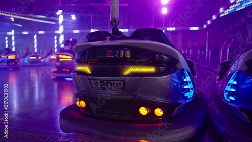 Munich, Germany. Fast bumper cars action at Theresienwiese amusement ride. Excitement and laughter as people steering dodgems through smoke machine atmosphere at Munich funfair.