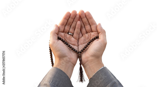Human hands cupped together while holding brown wooden prayer beads for religious worship and spiritual meditation