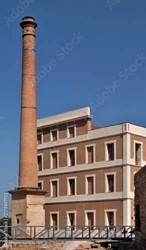 Old brick factory chimney and industrial building. Tortosa, Tarragona - Spain