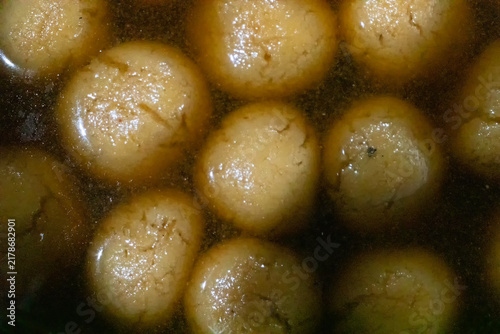 фотографія Rasgulla, a popular Indian syrupy dessert It is made from ball-shaped dumplings of chhena - an Indian cottage cheese and semolina dough, cooked in light syrup made of sugar