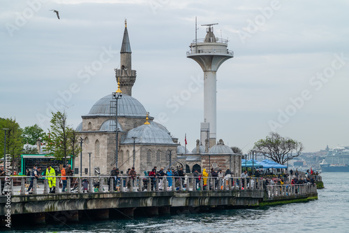 Canvastavla Tourists explore historic mosque beside modern observation tower