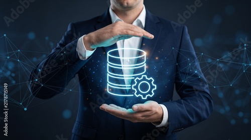 Plakat w ramie Database Management and Data Processing Technology with Businessman and Hologram Icon