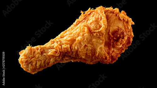 Crispy fried chicken drumstick isolated on black background