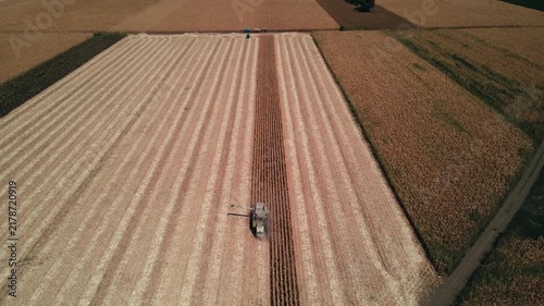 Aerial View of Combine Harvester Harvesting Corn Field