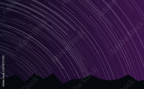 Fotografie Long exposure star trails in a dark purple night sky