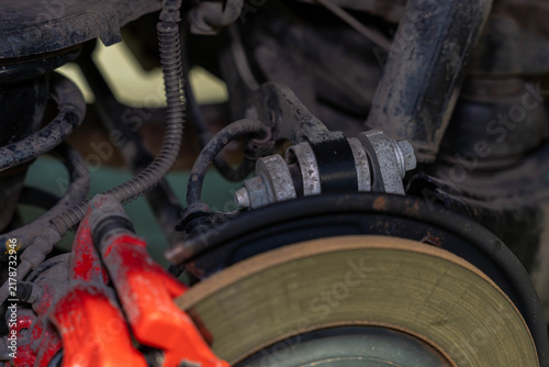 Fotografie Wheel repair close up with brake rotor and dirty suspension hardware