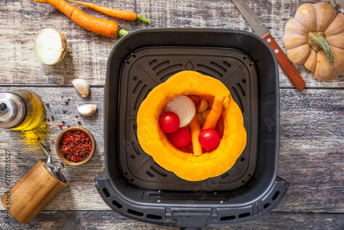 Step 4. The process of cooking pumpkin vegetarian soup in an air fryer, in kitchen gadget modern. Lifestyle trendy of new cooking. Healthy cooking with air fryer.
