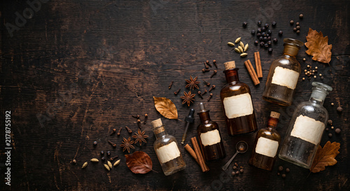 Top down flat lay of vintage apothecary bottles and spices with copy space