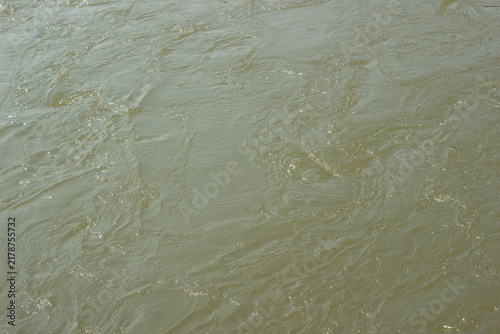Принти на полотні Muddy river water stream background with fast flowing liquid motion and swirling