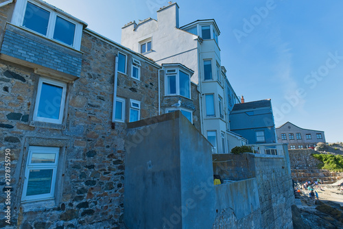 Фотография A bright, low-angle photo of multi-story buildings with light-colored walls and