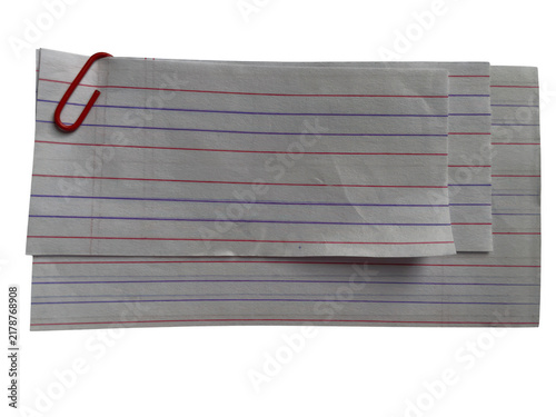 Stack of grey paper sheets with red and blue vertical lines held together by a simple metal paper clip top
