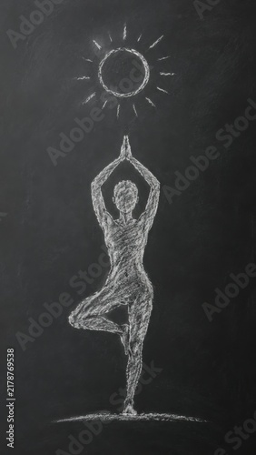 Chalk drawing of a human figure in a yoga pose with hands raised towards a sun symbol on a blackboard background, emphasizing balance and tranquility in a minimalist style