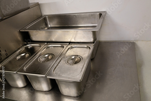 stainless steel food storage containers in commercial kitchen