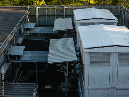 Aerial view of a traction substation featuring white modular units, metal roofing, and complex electrical cabling in Rouse Hill, Sydney, New South Wales, Australia.