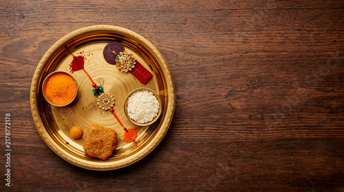 Traditional decorated brass pooja thali with diyas and sweets for Diwali