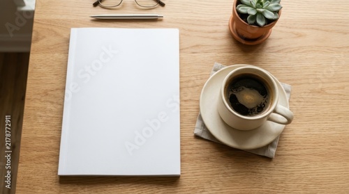 Blank white book cover mockup on a wooden desk next to a cup of black coffee, a small succulent plant, eyeglasses, and a pen in a clean and bright home office workspace setting