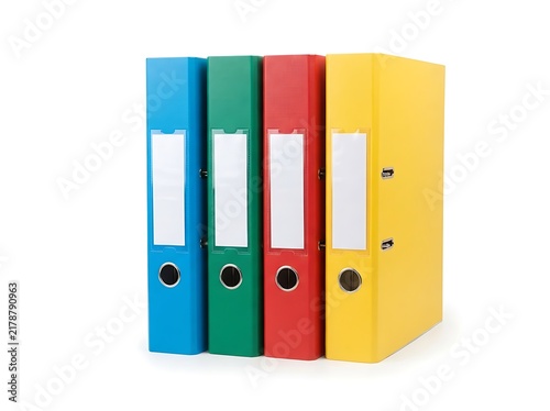 An isolated image of four vibrant ring binders with label holders on a white background