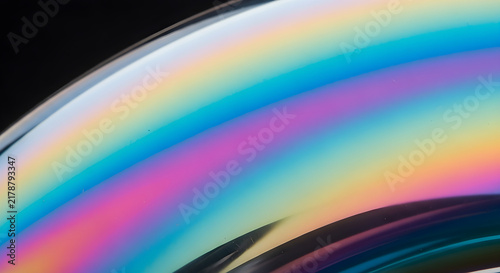 Iridescent Soap Bubble Macro Close Up Featuring Vibrant Holographic Colors and Abstract Light Refractions on a Dark Background