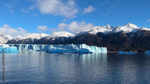 Perito Moreno Glacier in Los Glaciares National Park, Patagonia, Argentina, viewed from a boat. The massive blue-white ice wall rises above the waters of Lago Argentino, part of the vessel visible