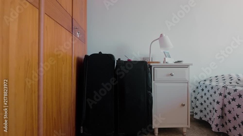 Packed suitcases ready for a trip in a bedroom