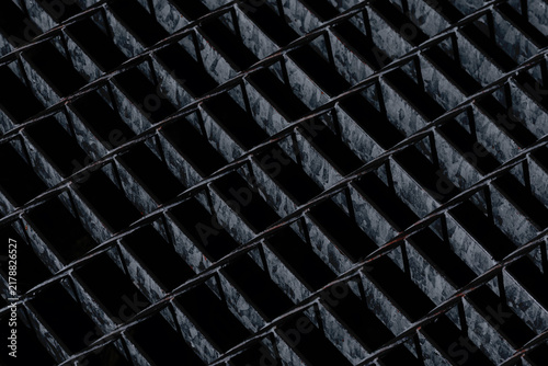 Dark Industrial Metal Grating with Repeating Geometric Pattern