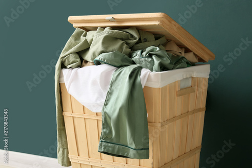 Konstfotografi Household chores and laundry organization, overflowing wooden hamper with messy