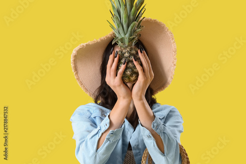Canvastavla Beautiful young woman in beachwear with pineapple on yellow background