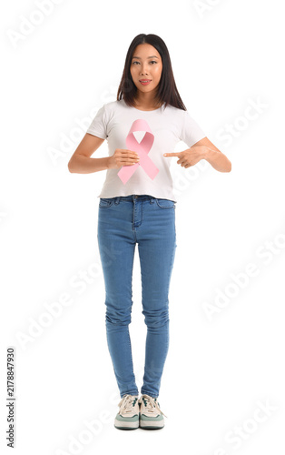 Young Asian woman pointing at pink ribbon on white background. Breast cancer ...
