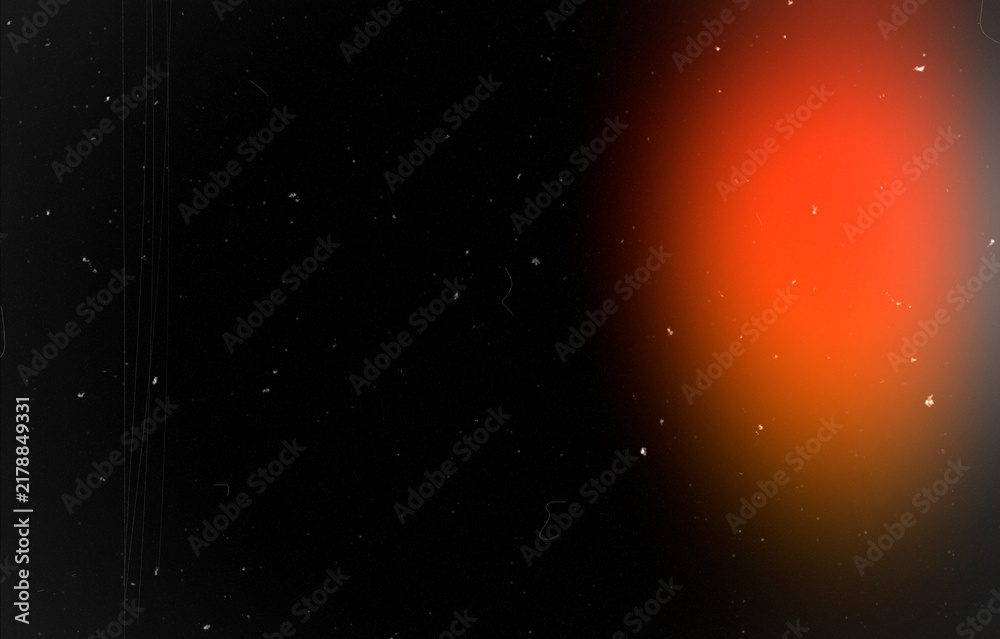 Fototapeta premium Abstract dark background with orange glow, dust particles and scratches. Cinematic retro film texture for vintage poster