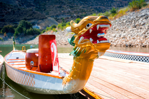 Close-up of sport dragon boat parked at the jetty on the lake