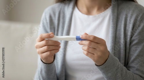 Millennial female expecting baby and undergoing IVF fertility or infertility treatment