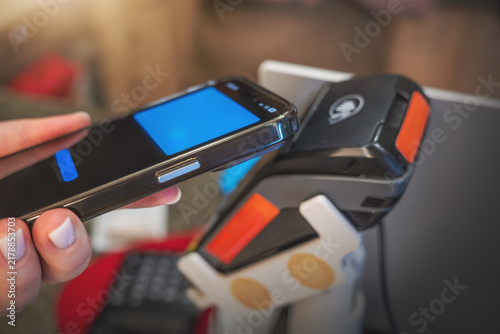 Contactless mobile payment smartphone POS terminal NFC digital wallet transaction, cashless fintech technology, secure retail checkout and banking innovation.