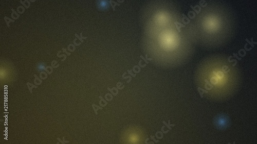 Dark charcoal background, with glowing yellow, and blue circular, light bokeh effects, and a subtle, grainy texture throughout