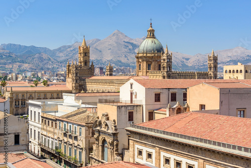 Palermo Cathedral rises above rooftops against Sicilian mountains