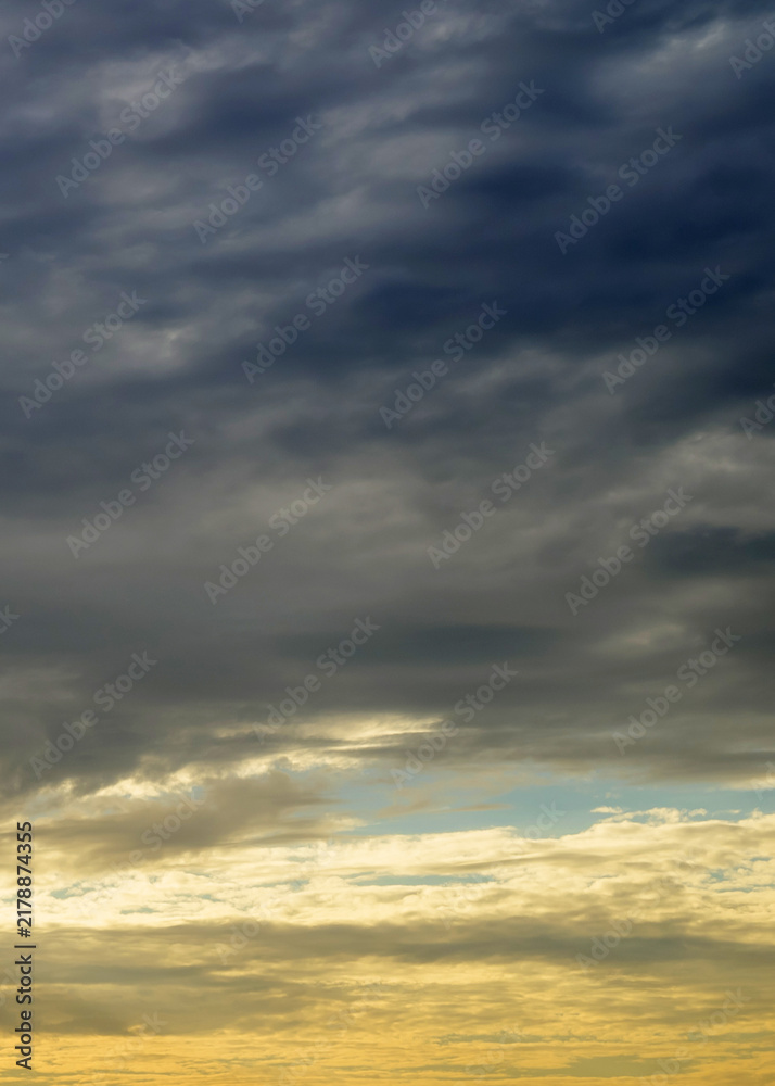 Fototapeta premium overcast twilight sky with soft orange and yellow light near horizon line