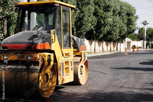 Photography Heavy Yellow Road Roller Machine Compacting Fresh Asphalt on Suburban Street Con