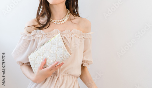 A dressed-up woman carrying a party bag