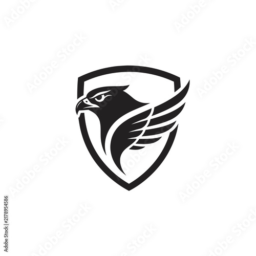 Black eagle head with wings inside shield logo, heraldic emblem, vector graphic