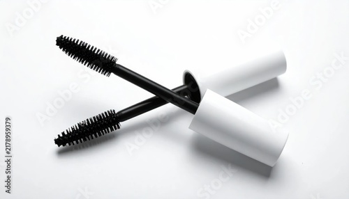 Obraz na płótnie Two applicators, one open, cross on a white surface, showcasing the brush tips