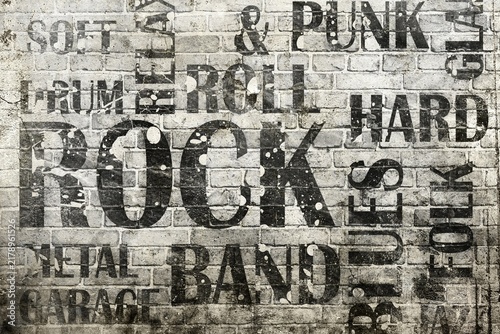 Grunge brick wall background with black painted rock music typography