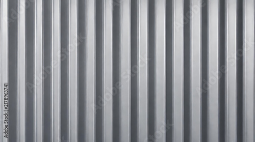 Close up of modern grey vertical ribbed metal panel wall texture with sleek lines for industrial architecture and background design