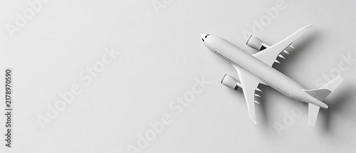 Overhead view of a white airplane model on a light gray background