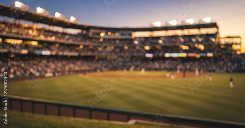 A baseball stadium at sunset melts into warm cinematic blur, combining glowing floodlights, soft seating, and golden field tones for an atmospheric sports background