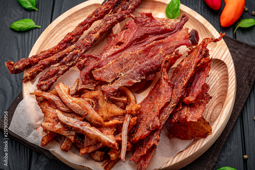 Konstfotografi Variety of dried meats served on a wooden plate