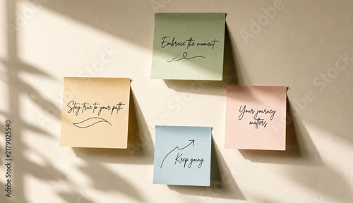 Cuadro en lienzo Colorful motivational sticky notes arranged on light wall surface
